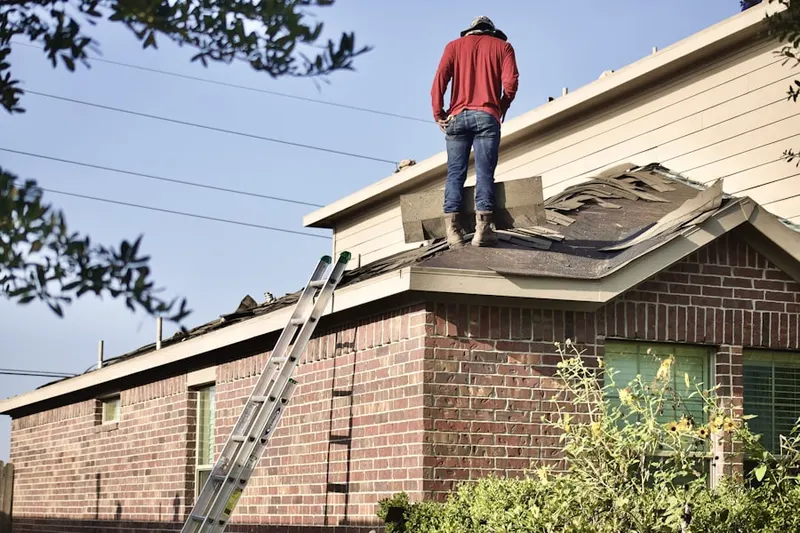 Professional roofer working on a residential roof in Lakewood Mutual